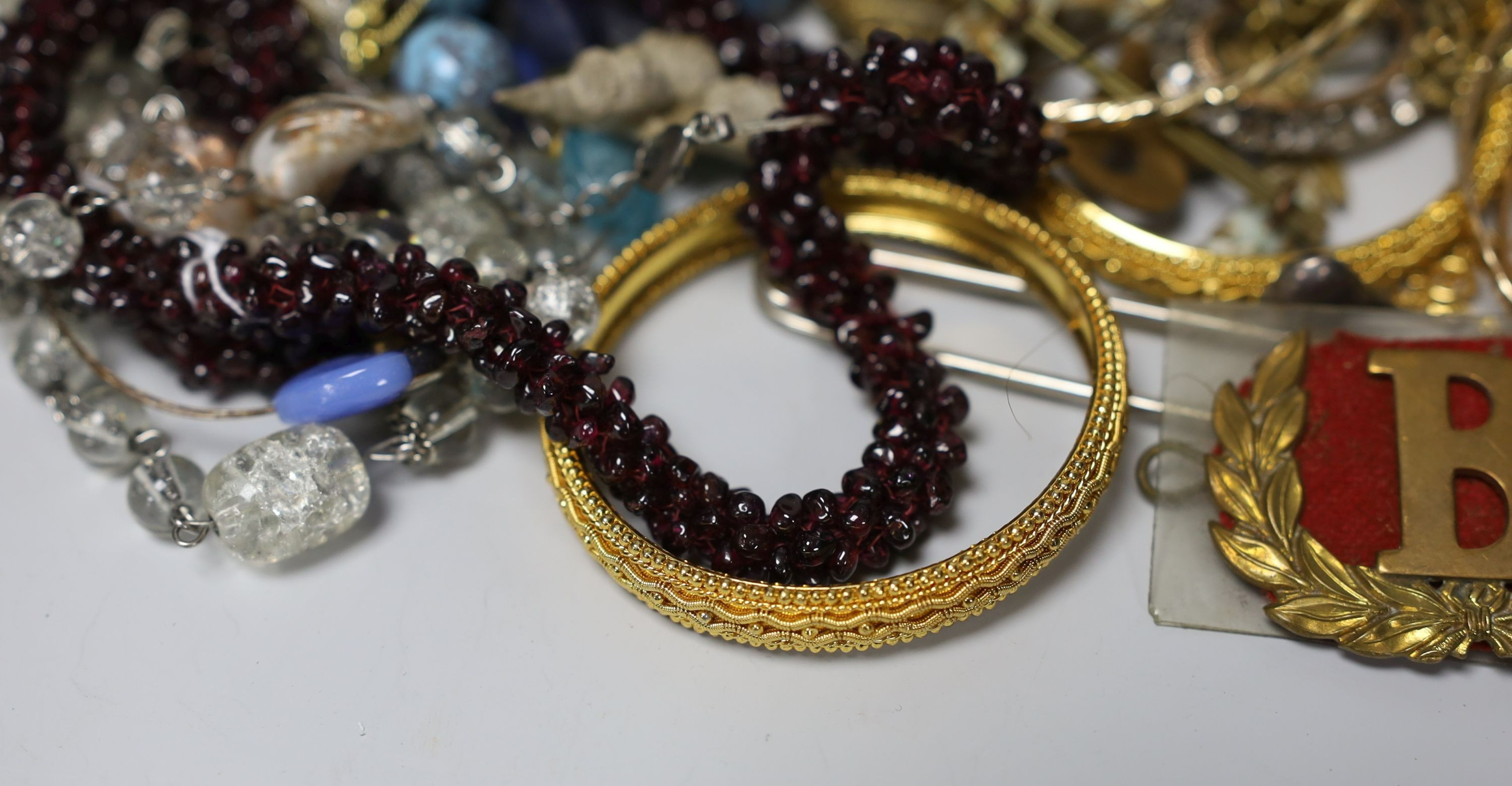 A quantity of assorted costume jewellery and other items including silver and enamel plaque and a garnet bead necklace.